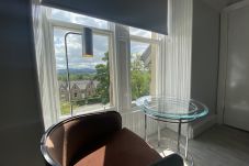 A comfortable bedroom with natural light and a plush bed in No6 West Coates, Haymarket, Edinburgh.