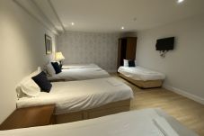 Comfortable twin single beds in the 6-person room at Park View House Hotel.