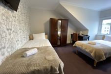 Cozy family room with a double bed and two single beds at Park View House Hotel.