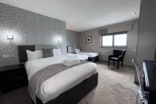 Spacious Family Room at Richmond Park Hotel Bo'ness, featuring a king bed, two single beds, and modern amenities.